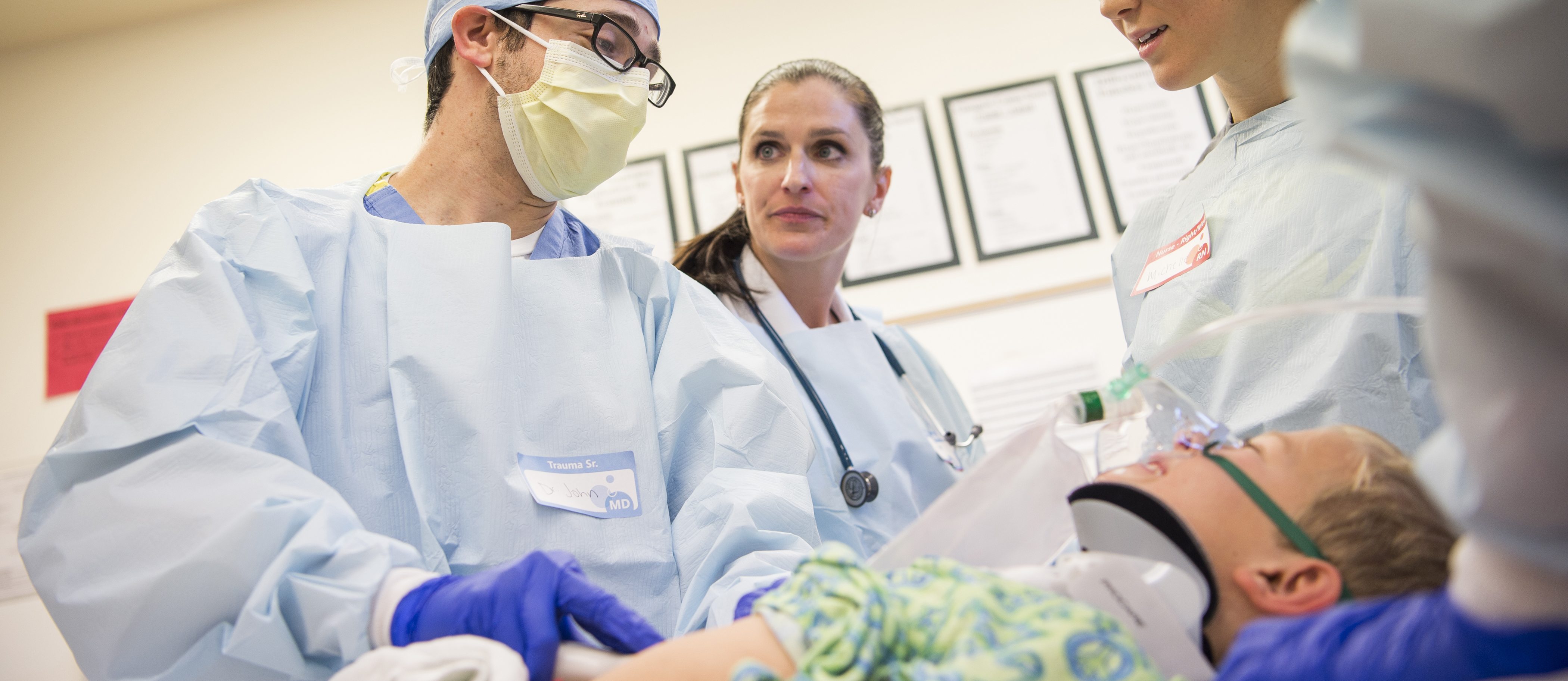 clinicians with pediatric patient at bedside