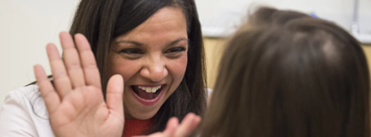 clinician giving a high five to patient