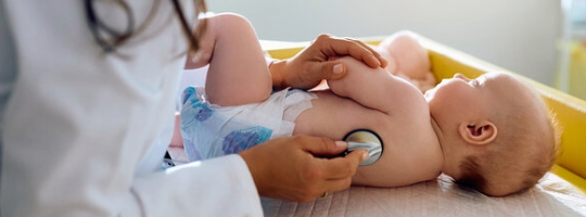 Infant being examined by provider