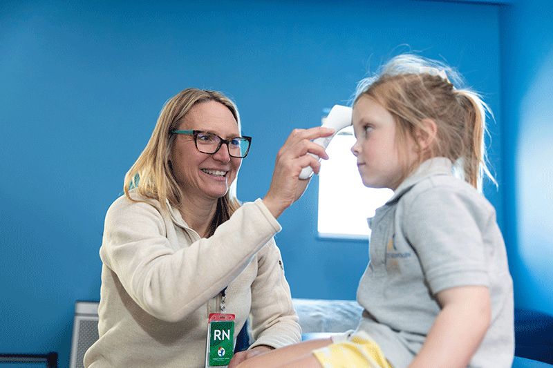 Nurse examining school age child